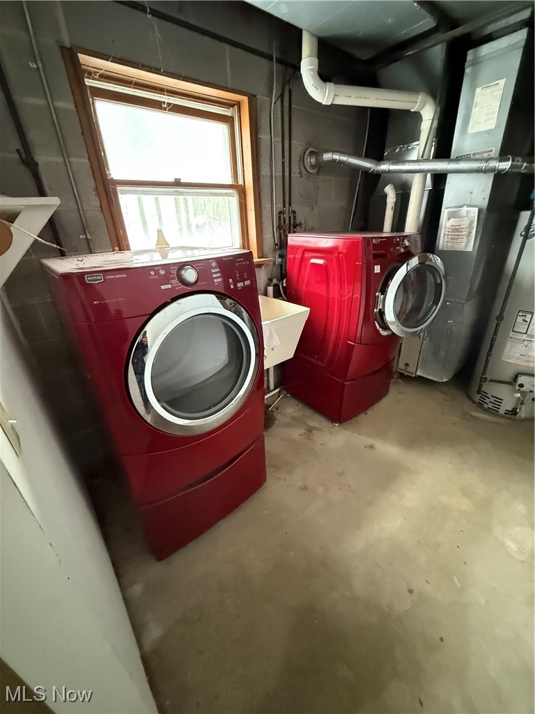8335 Shepard Road Macedonia, OH 44056 - Photo 17 of 17 Laundry room with water heater, unfinished concrete flooring, washing machine and dryer, and heating unit