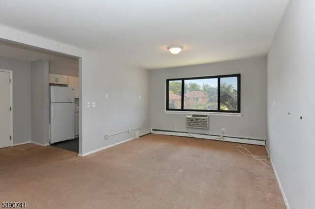 an empty room with a empty space and windows