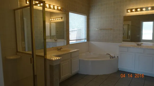 a bathroom with a bathtub and shower