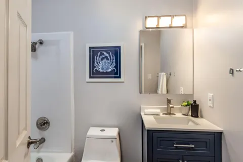 a bathroom with a sink toilet and mirror