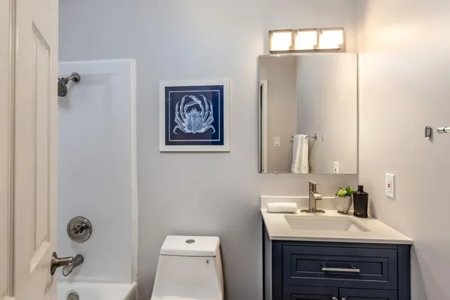 a bathroom with a sink toilet and mirror