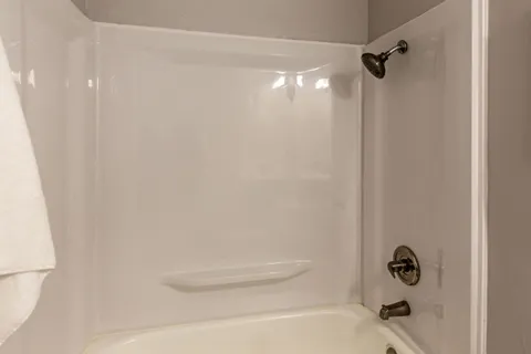 a bathroom with a shower and a tub
