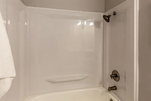 a bathroom with a shower and a tub