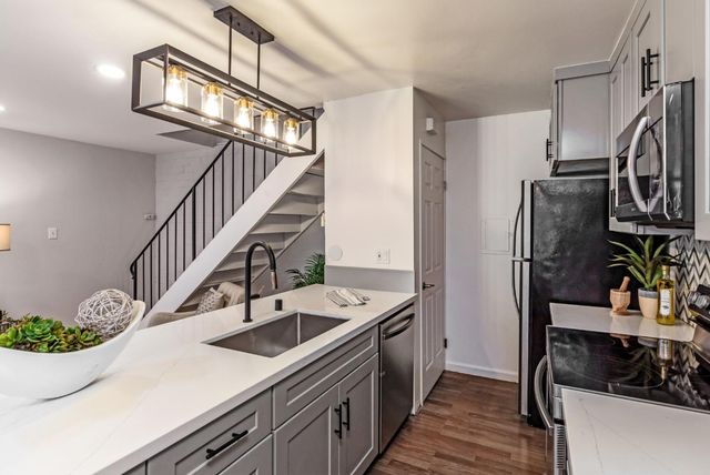 a kitchen with stainless steel appliances kitchen island a refrigerator and a stove
