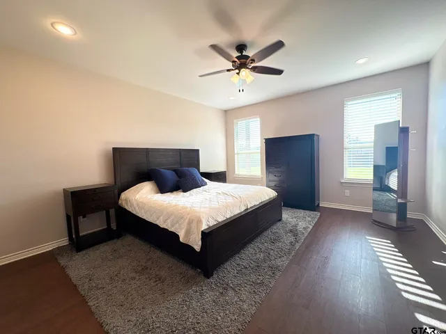 a bedroom with a bed and a television