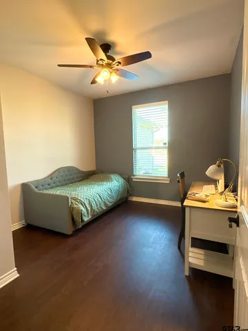 a spacious bedroom with a bed and a chandelier