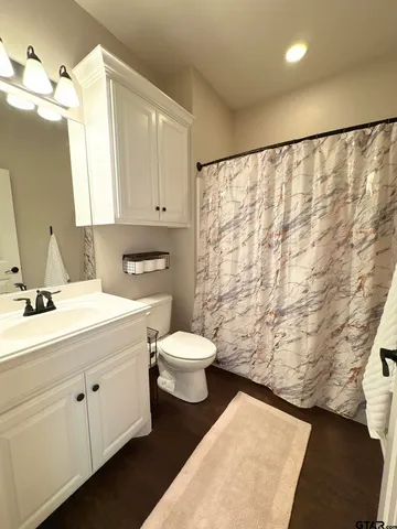 a bedroom with a bed dresser and a window