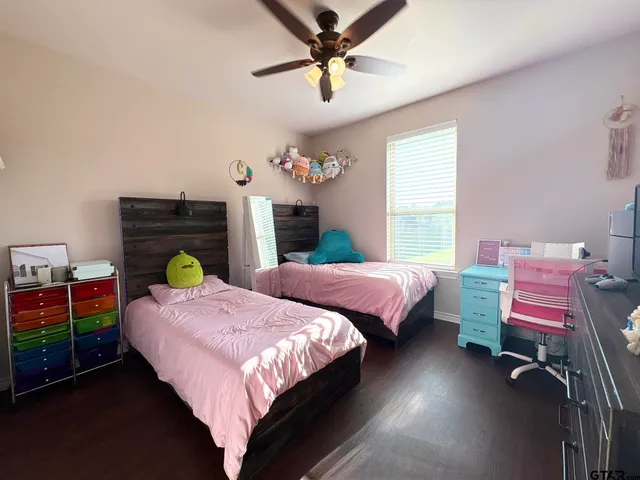 a bedroom with two beds and a chandelier