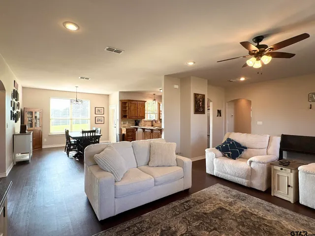 a living room with furniture and wooden floor
