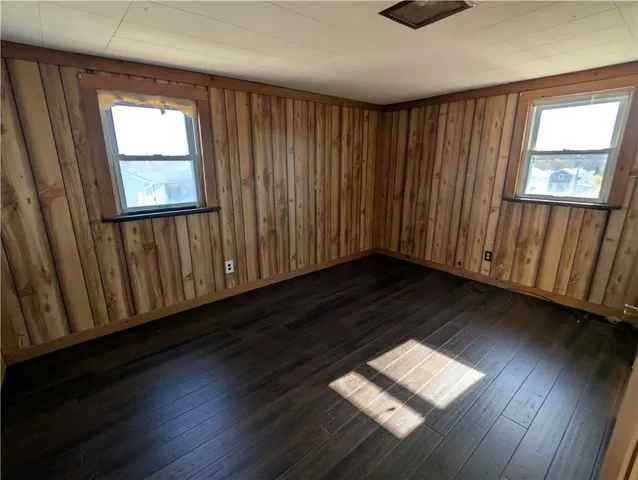 an empty room with windows and closet