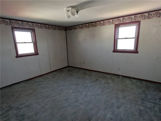 a view of a hallway with chairs and a window