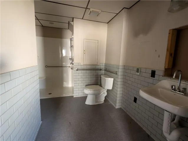 a bathroom with a tub a sink and a shower