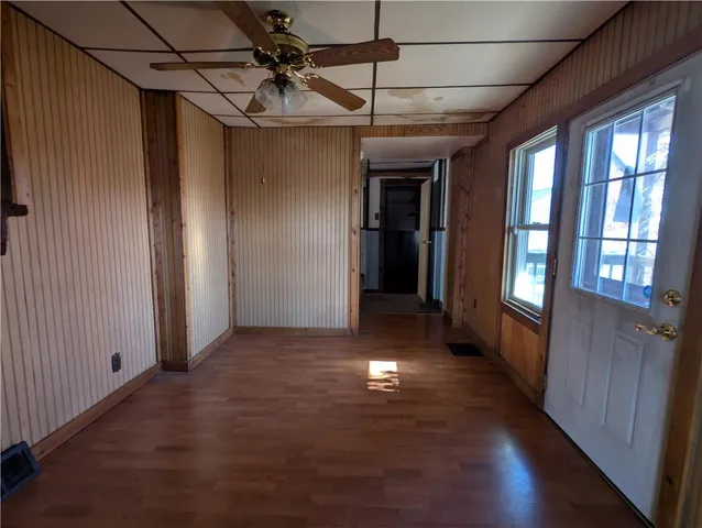 a view of hallway with wooden floor and chandelier
