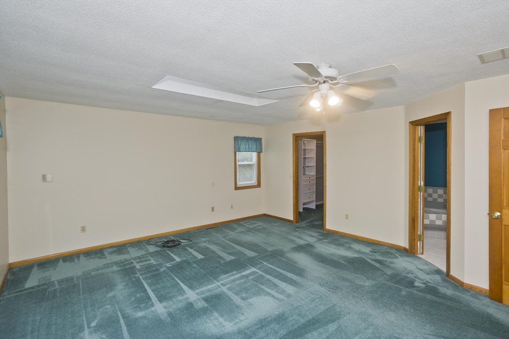 27 Bunker Circle East Longmeadow, MA 01028 - Photo 15 of 36 an empty room with closet and a ceiling fan