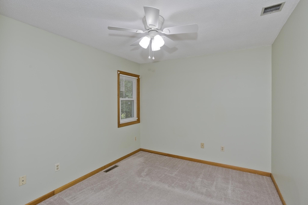 27 Bunker Circle East Longmeadow, MA 01028 - Photo 20 of 36 an empty room with a window and a fan