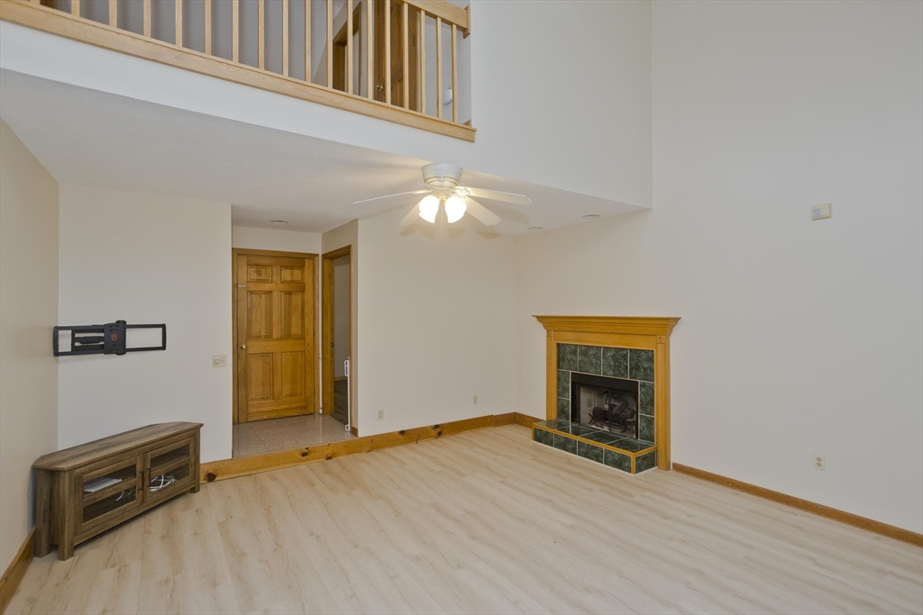 27 Bunker Circle East Longmeadow, MA 01028 - Photo 2 of 36 a view of an empty room with wooden floor and a window