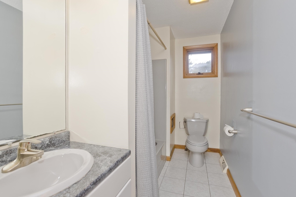 27 Bunker Circle East Longmeadow, MA 01028 - Photo 24 of 36 a bathroom with a granite countertop sink and a mirror