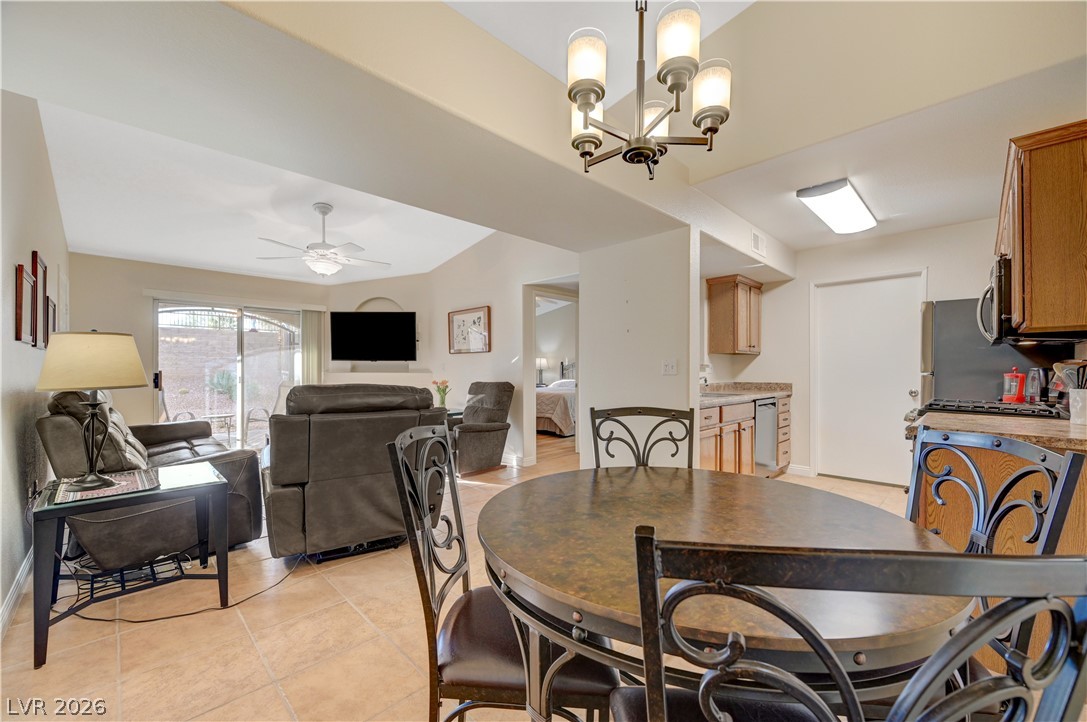 7885 West Flamingo Road, Unit 1071 Las Vegas, NV 89147 - Photo 28 of 28 An inviting open floorplan seamlessly connects the dining area, living room, and a well-appointed kitchen.