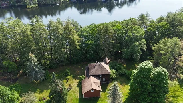 a backyard of a house with lots of green space and lake view