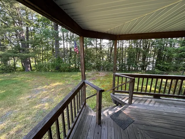 a view of yard with swimming pool and trees in the background