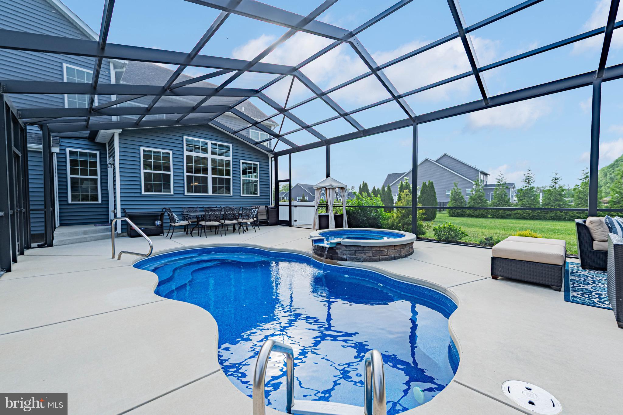 36932 Grove Estate Road Lewes, DE 19958 - Photo 17 of 105 a view of a patio with swimming pool table chairs and a yard