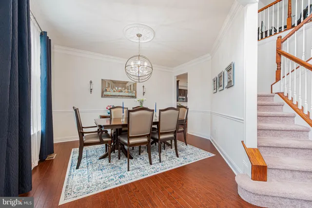 a living room with a mirror and a wooden floor