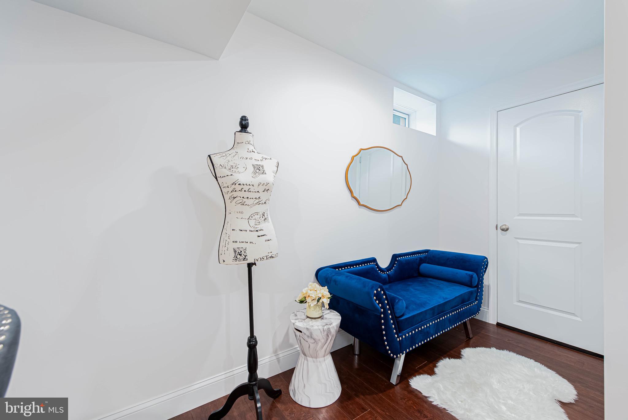 36932 Grove Estate Road Lewes, DE 19958 - Photo 89 of 105 a living room with a mirror and a wooden floor