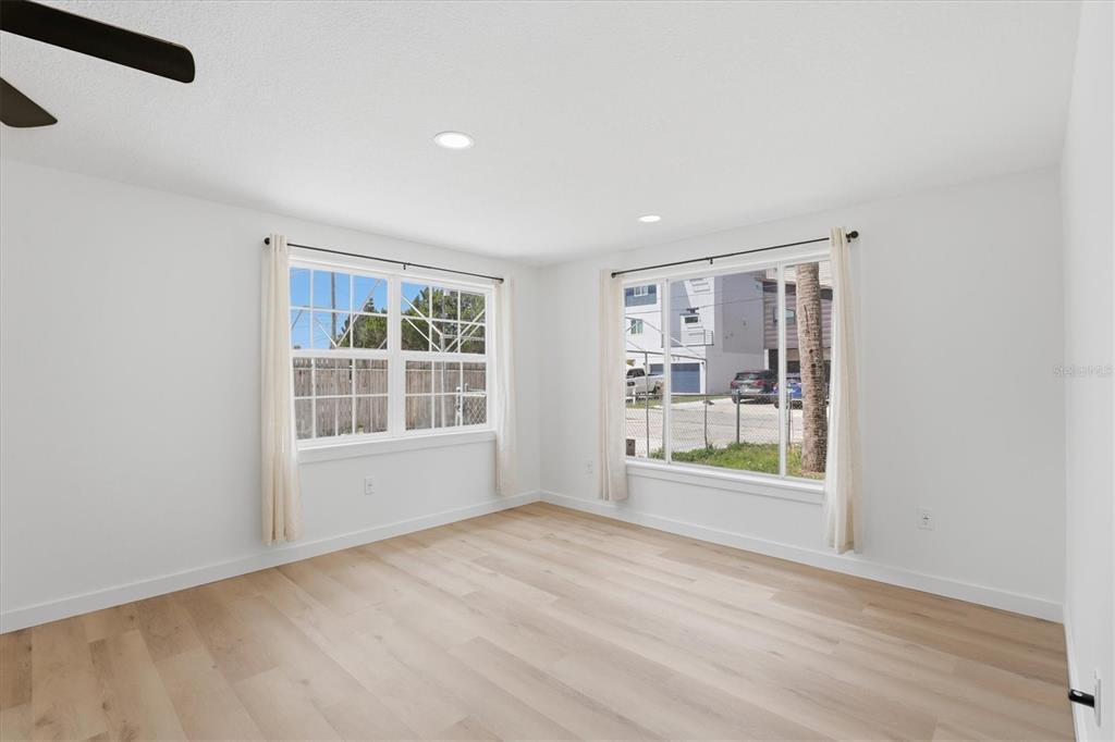 7114 Fair Lane Hudson, FL 34667 - Photo 15 of 59 an empty room with wooden floor and windows