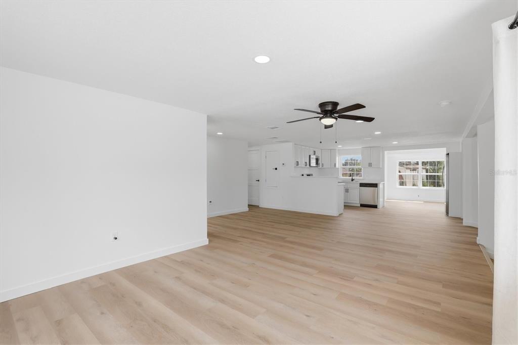 7114 Fair Lane Hudson, FL 34667 - Photo 16 of 59 a view of a livingroom with a ceiling fan window and wooden floor