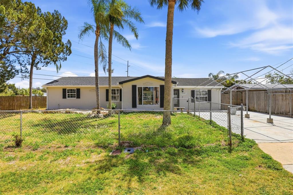 7114 Fair Lane Hudson, FL 34667 - Photo 2 of 59 a view of a house with a backyard and a tree