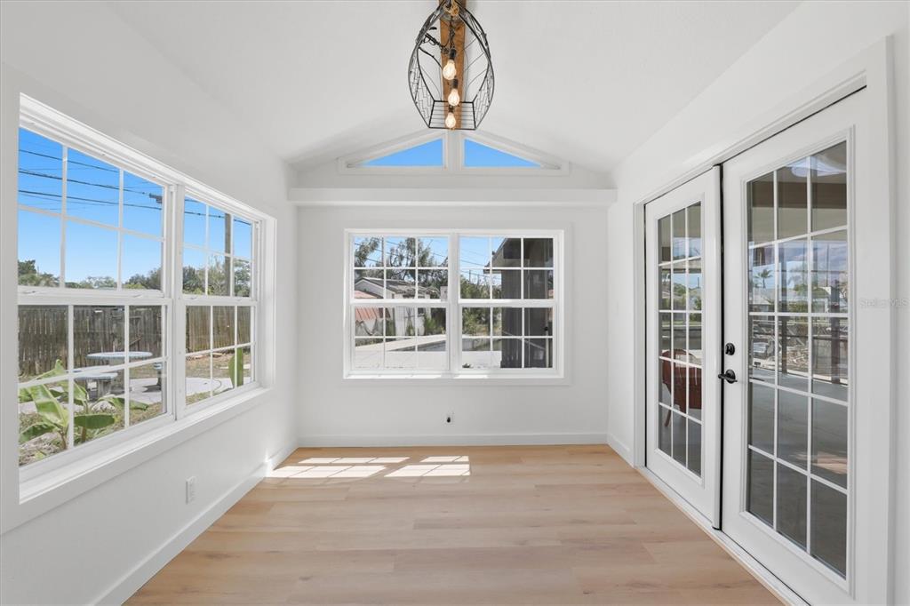 7114 Fair Lane Hudson, FL 34667 - Photo 24 of 59 a view of an entryway with wooden floor and windows