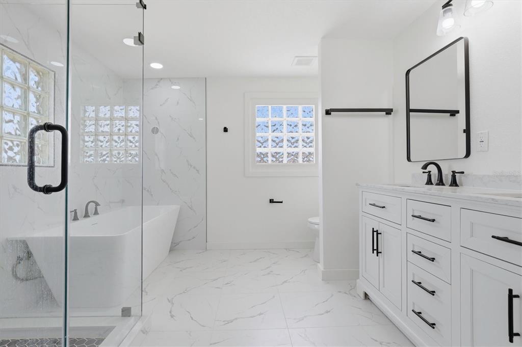 7114 Fair Lane Hudson, FL 34667 - Photo 31 of 59 a bathroom with a sink and a mirror