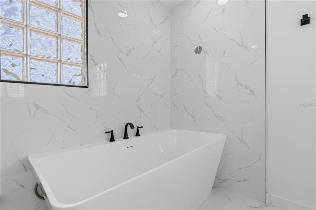 7114 Fair Lane Hudson, FL 34667 - Photo 34 of 59 a white bath tub sitting next to a white wall