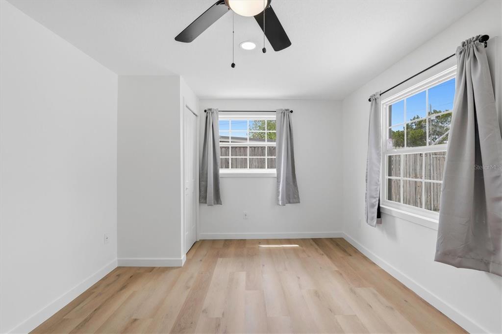 7114 Fair Lane Hudson, FL 34667 - Photo 37 of 59 wooden floor in an empty room with a window