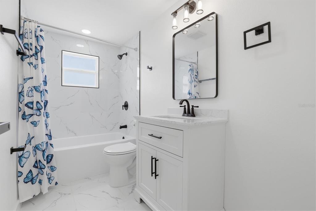 7114 Fair Lane Hudson, FL 34667 - Photo 39 of 59 a bathroom with a sink a toilet and shower