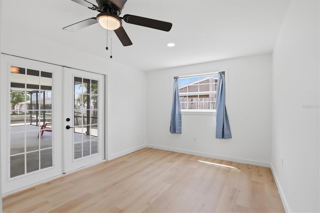 7114 Fair Lane Hudson, FL 34667 - Photo 40 of 59 a view of an empty room with a window and wooden floor