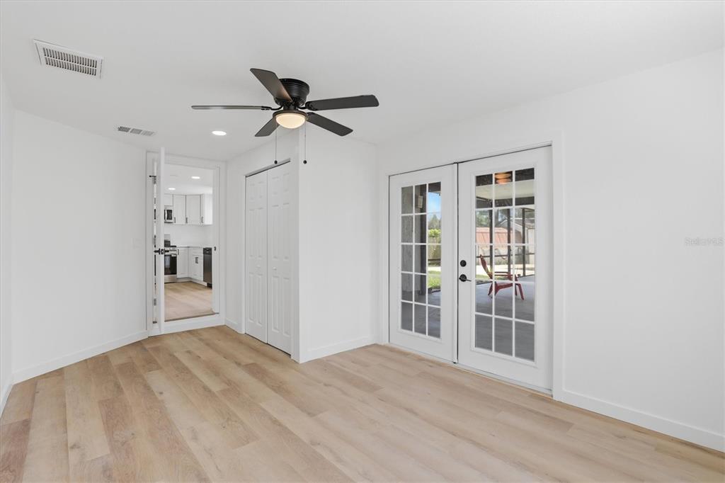 7114 Fair Lane Hudson, FL 34667 - Photo 41 of 59 a view of a livingroom with wooden floor and a ceiling fan