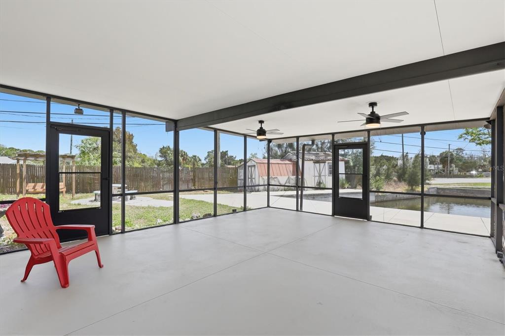 7114 Fair Lane Hudson, FL 34667 - Photo 44 of 59 a view of an empty room with wooden floor and windows