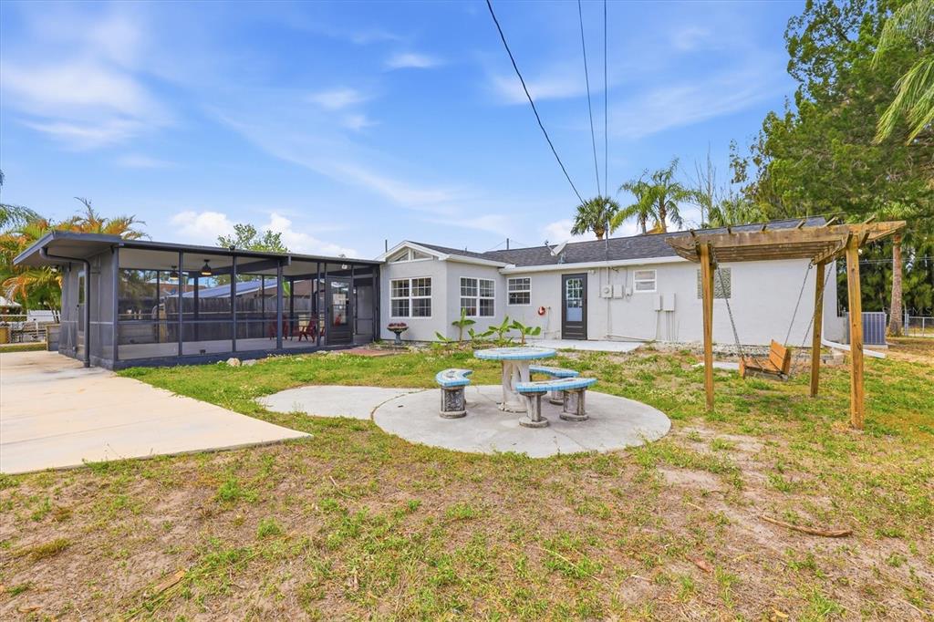 7114 Fair Lane Hudson, FL 34667 - Photo 47 of 59 a front view of a house with swimming pool having outdoor seating