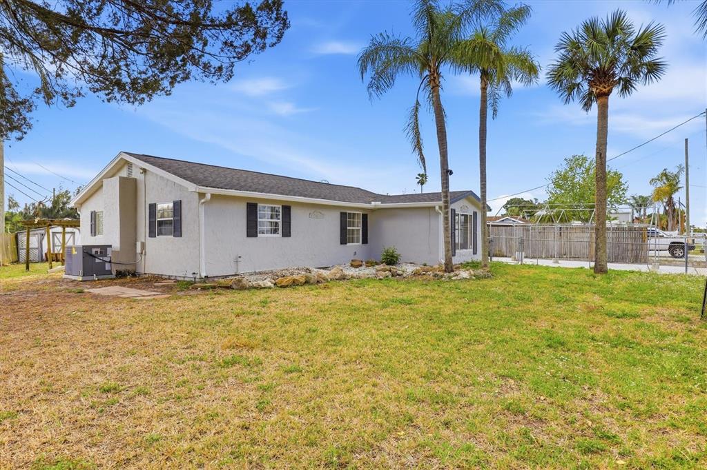 7114 Fair Lane Hudson, FL 34667 - Photo 59 of 59 a view of a house with a yard and palm trees