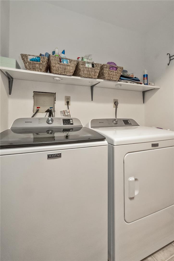 5728 Pheasant Road Bethlehem, PA 18017 - Photo 33 of 39 A functional laundry space features side-by-side appliances and a long overhead storage shelf.
