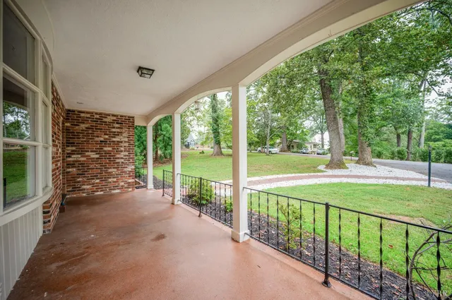 a view of porch with a floor to ceiling window next to a yard