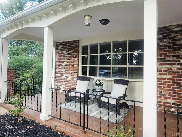 a balcony with table and chairs