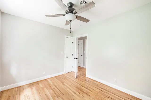a view of a house with a yard and tree s
