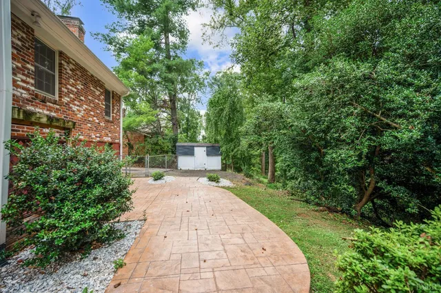 an aerial view of a house with a yard and lake view