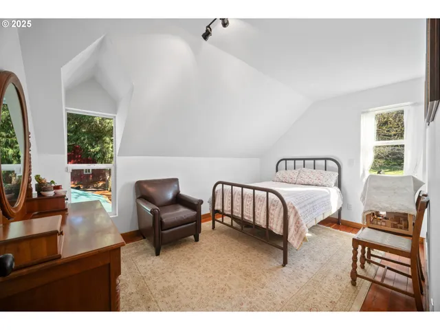 a bedroom with furniture and a large window