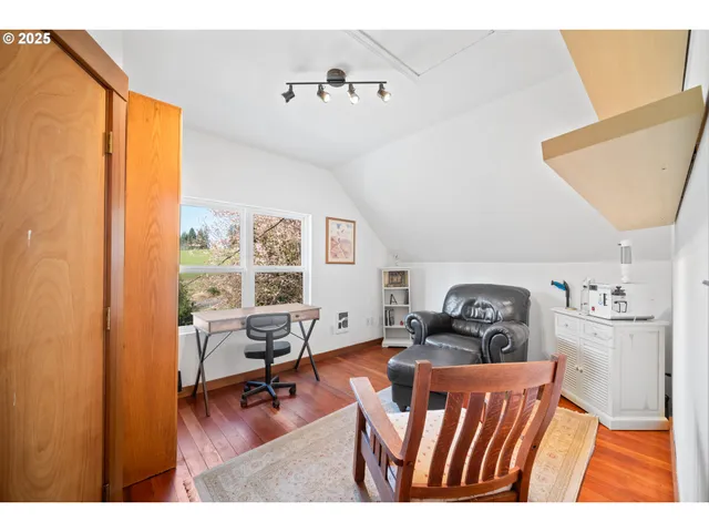 a bedroom with furniture and a wooden floor