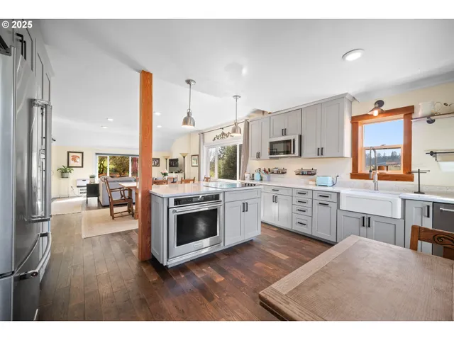 a open kitchen with cabinets a stove and a wooden floor