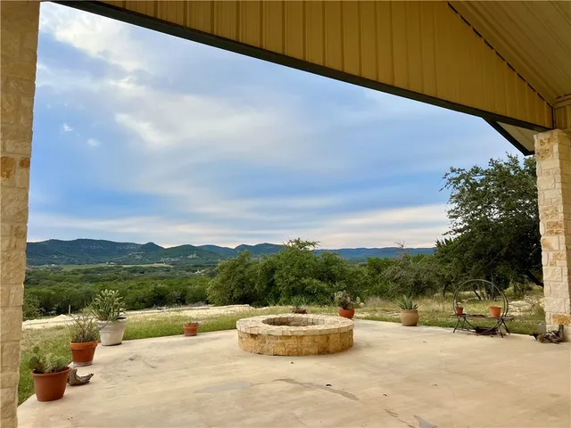 a view of a house with a yard and a sitting area