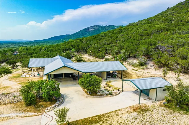 a small pool with lawn chairs and a fire pit